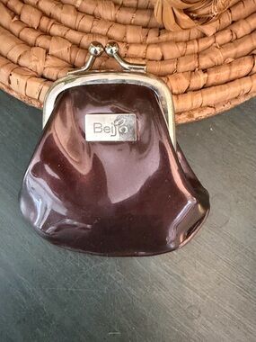 Beijo patent leather coin purse features a dark chocolate brown
